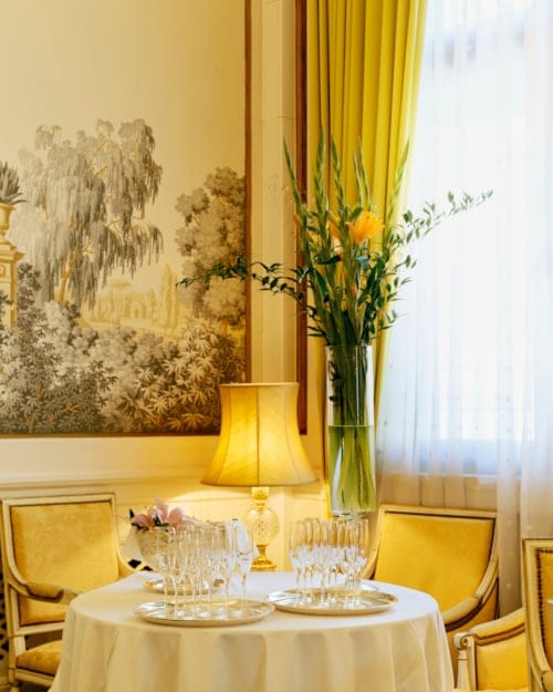 Elegant corporate meeting setup at Hotel Bristol with floral decor and soft lighting.