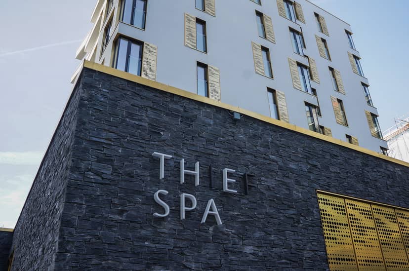 Modern spa with stone facade and golden accents, ideal for wellness retreats and corporate events.