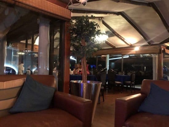 Karambezi Café lounge: cozy seating, green decor, corporate event