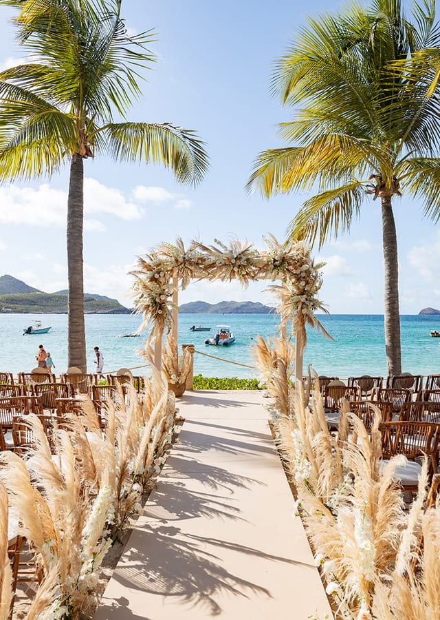 Beach wedding floral arch, intimate seating, destination event