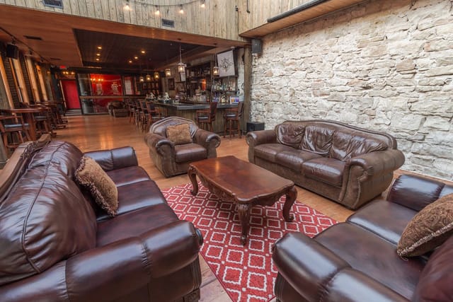 Rustic bar event space, leather seating, stone walls, cocktail reception, private dinner