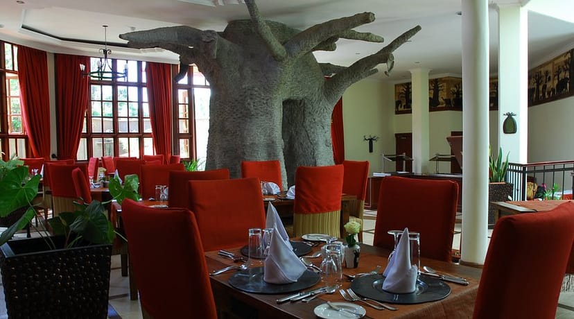 Baobab tree sculpture, red drapery, restaurant event, themed decor