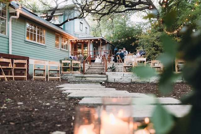 Outdoor wedding venue with string lights, rustic seating