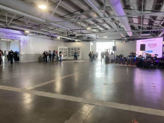 Industrial pop-up event space, concrete floor, stage & AV