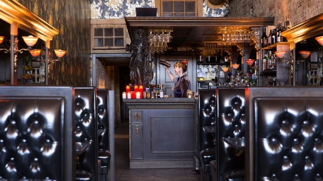Milonga cocktail reception | ornate bar | plush seating