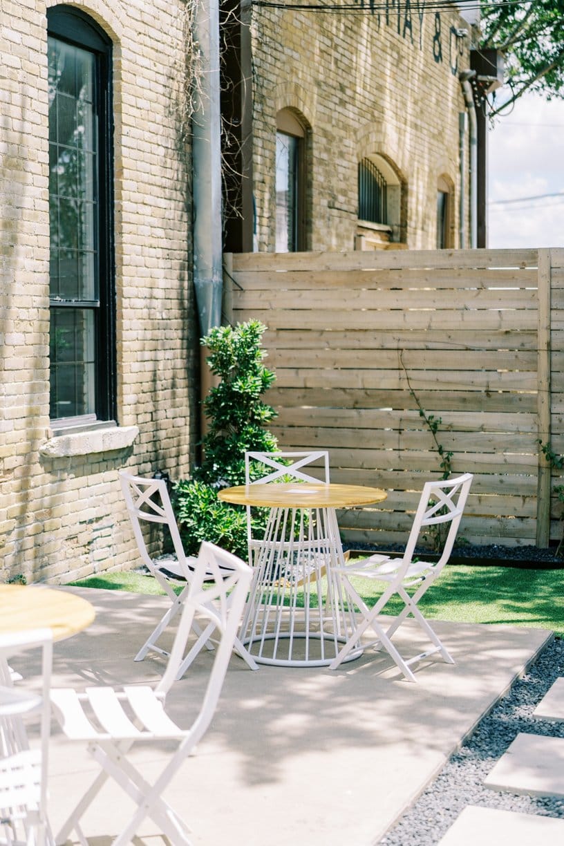 Urban garden courtyard event venue, rustic brick, bistro seating