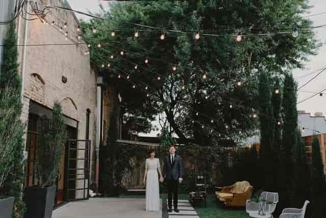 Outdoor courtyard wedding venue, string lights, industrial chic, event space