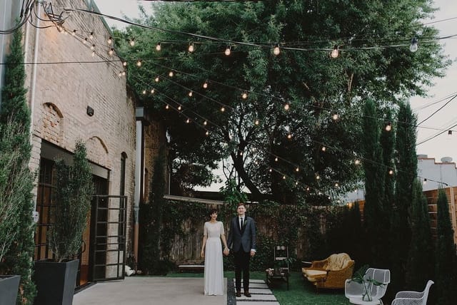 Outdoor courtyard wedding venue, string lights, industrial chic, event space