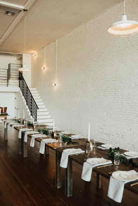 Industrial-chic venue: brick, stairs, dinner, workshop