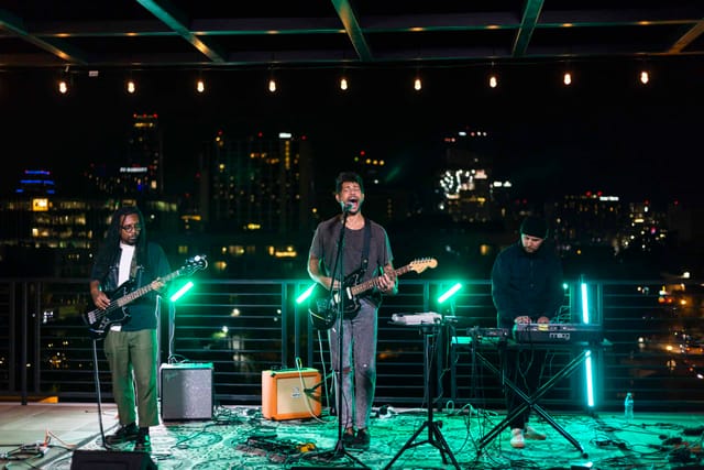 IYKYK rooftop concert, urban backdrop, VIP event