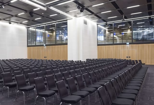 Modern conference room at Radisson Blu Stockholm with black chairs for events.