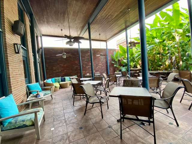 Outdoor patio event space with greenery, party, meeting.