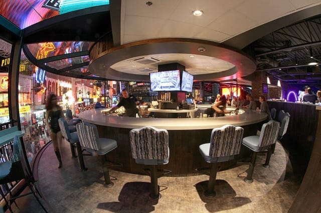 Vibrant saloon party room, circular bar, cocktail reception, networking event