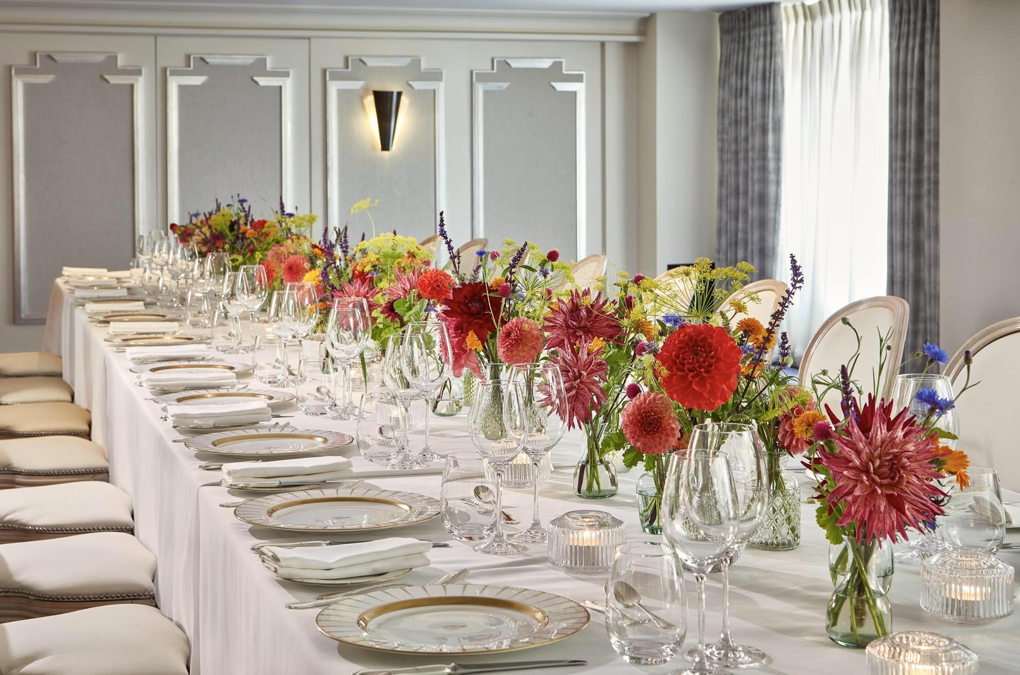 Elegant banquet table at Claridge's with floral centerpieces for corporate events.