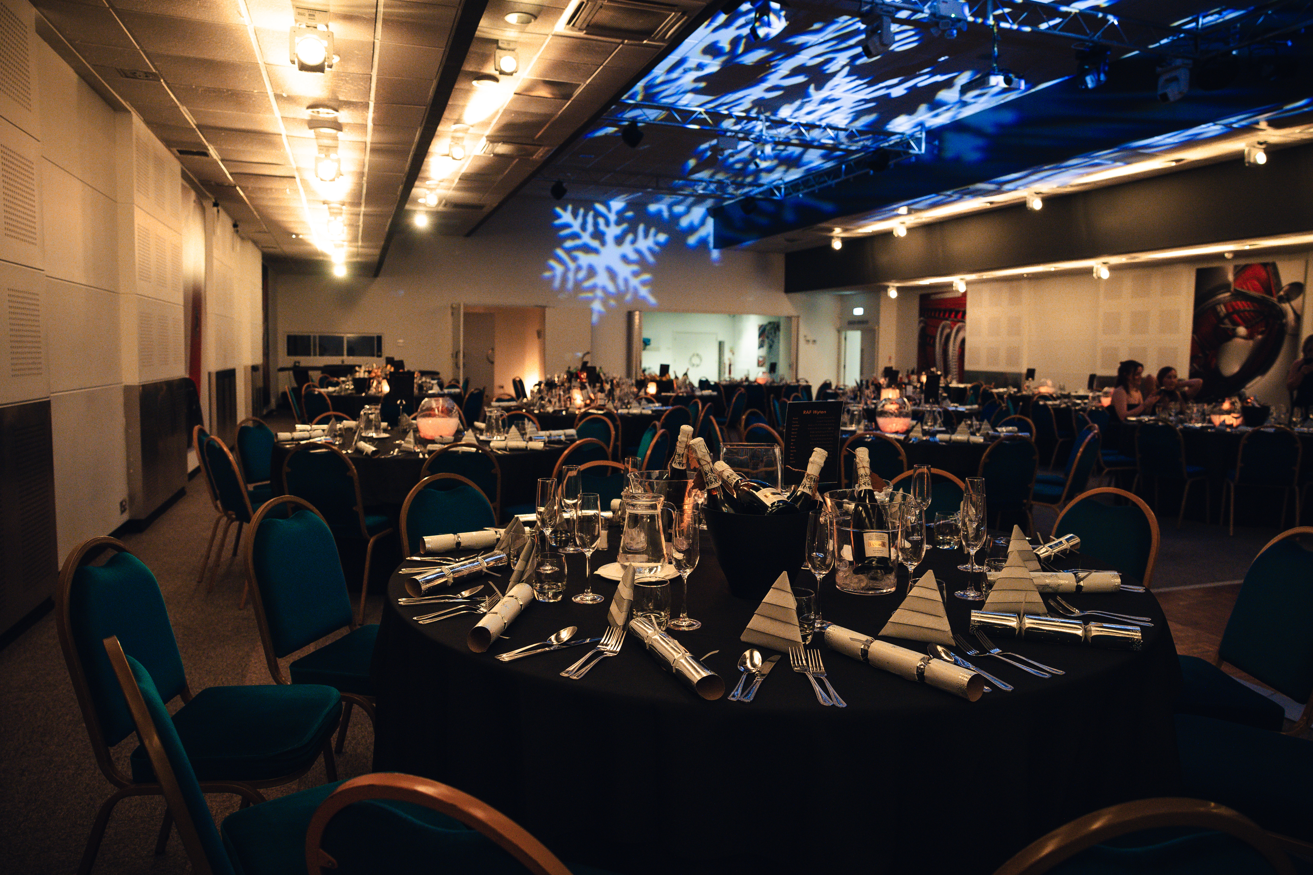 Elegant banquet room in Merlin Suite with black linens, ideal for upscale events and celebrations. - Banner