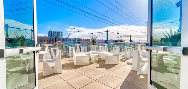Rooftop cocktail reception, modern patio, city networking