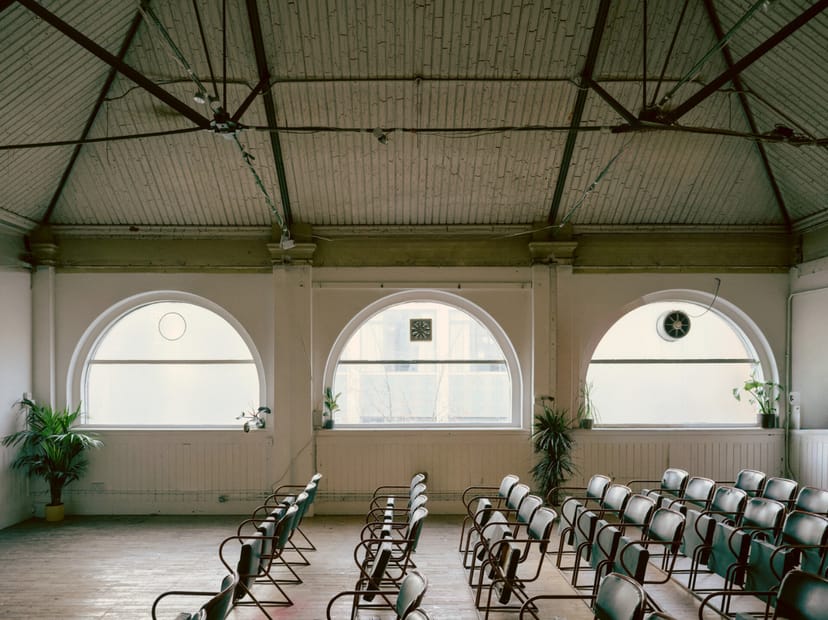 Playhouse East raw space venue, arched windows, event space