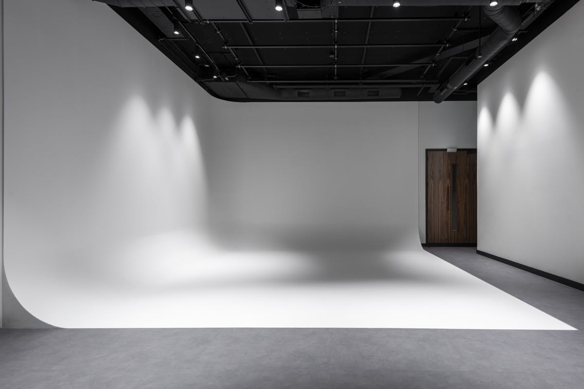 Versatile event space at Qube Elephant Lounge with seamless white backdrop for presentations.