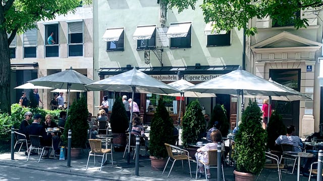 Viennese cafe networking event outdoor seating umbrellas