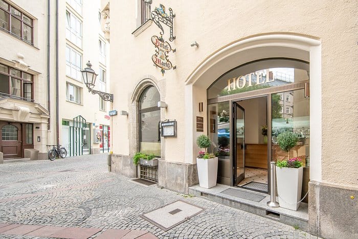 Munich hotel event, charming boutique entrance, cobblestone street.