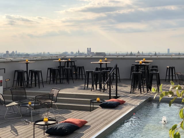 Rooftop bar terrace, city views, cocktail reception, networking event