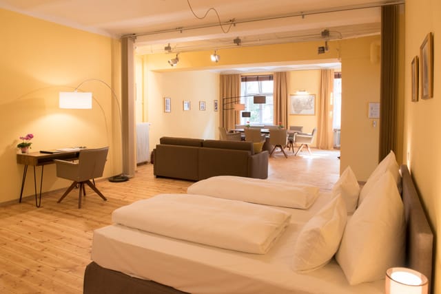 Loft suite with king bed, hotel meeting, executive retreat.