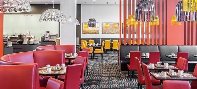 Munich event space, red banquette, yellow chairs, conference catering