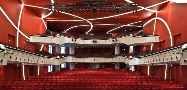 Munich theater stage, red seats, product launch event