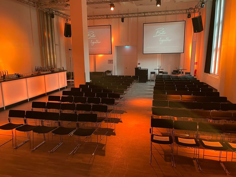 Industrial event hall, projector screens, conference venue