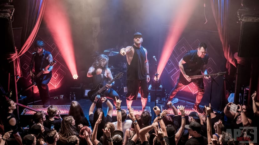 Concert backstage, sold-out crowd, stage lighting