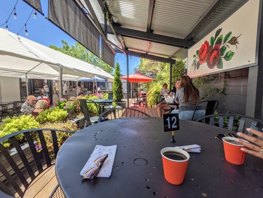 Cafe Frida outdoor patio with numbered tables for networking events and breakout sessions.