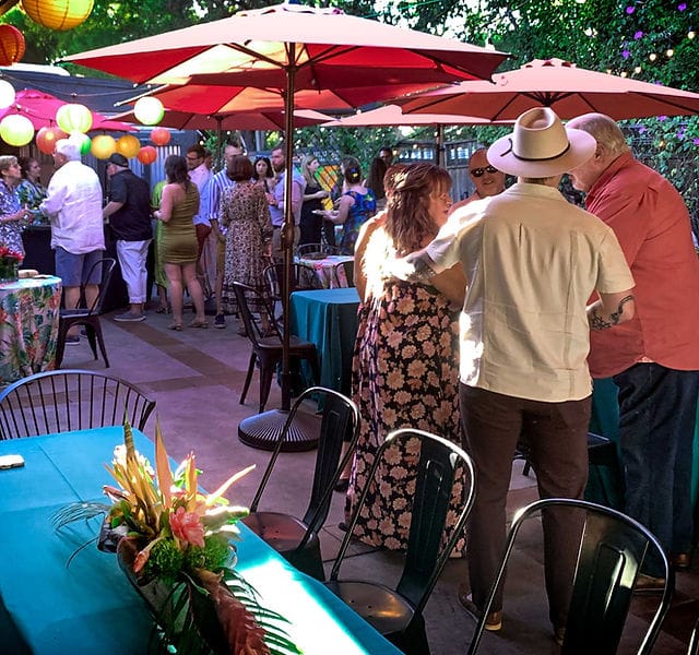 Outdoor networking reception at Café Frida Gallery with ambient lantern lighting.