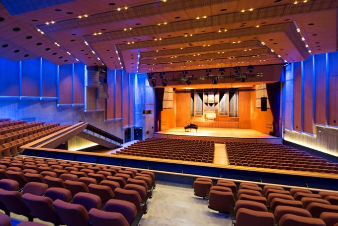 Congress Hall auditorium with blue lighting for keynote events and awards ceremonies.