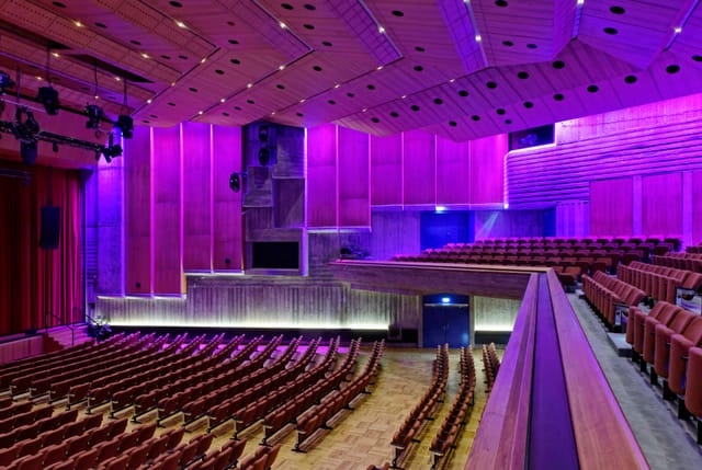 Purple-lit multi-level theater at Kongress am Park Augsburg for keynote and awards ceremony.