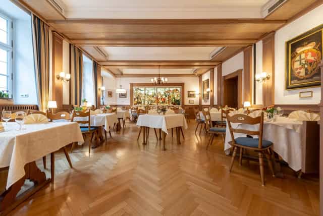 Elegant wood-paneled banquet room at Romantik Hotel zur Post for private dining and events.