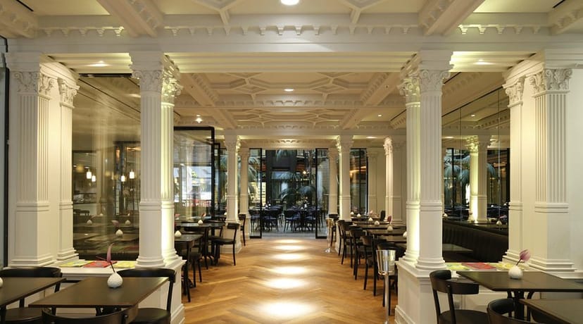 Neoclassical bar at Cafe Luitpold, elegant columned venue for upscale cocktail hours and events.