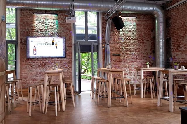 Schänke at Giesinger Bräu: Industrial-chic event space with high-top tables for networking mixers.