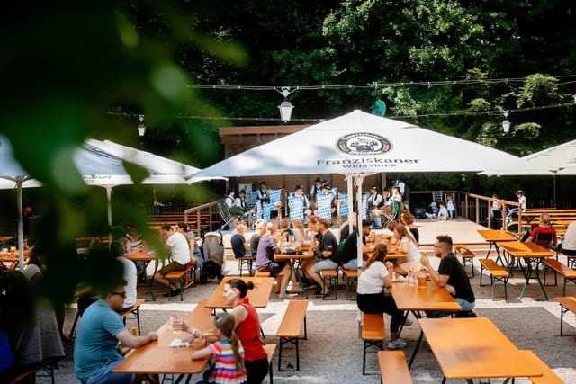 Gasthaus Domagk beer garden with communal benches, string lights for outdoor events and festivals.