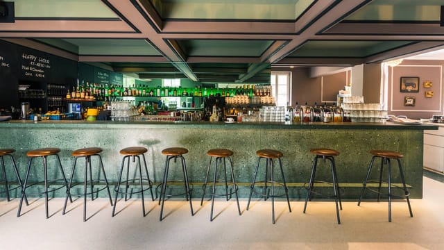 Industrial café lounge for corporate happy hour or professional networking mixer.