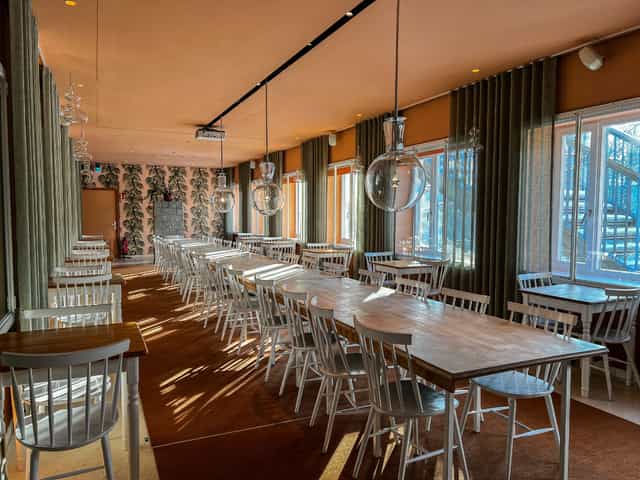 Orangerie at Café Reitschule: bright, long-table event space for workshops and banquets.