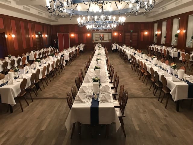 Isar Saal banquet hall with wood-paneled walls, ideal for large corporate events and gala dinners.