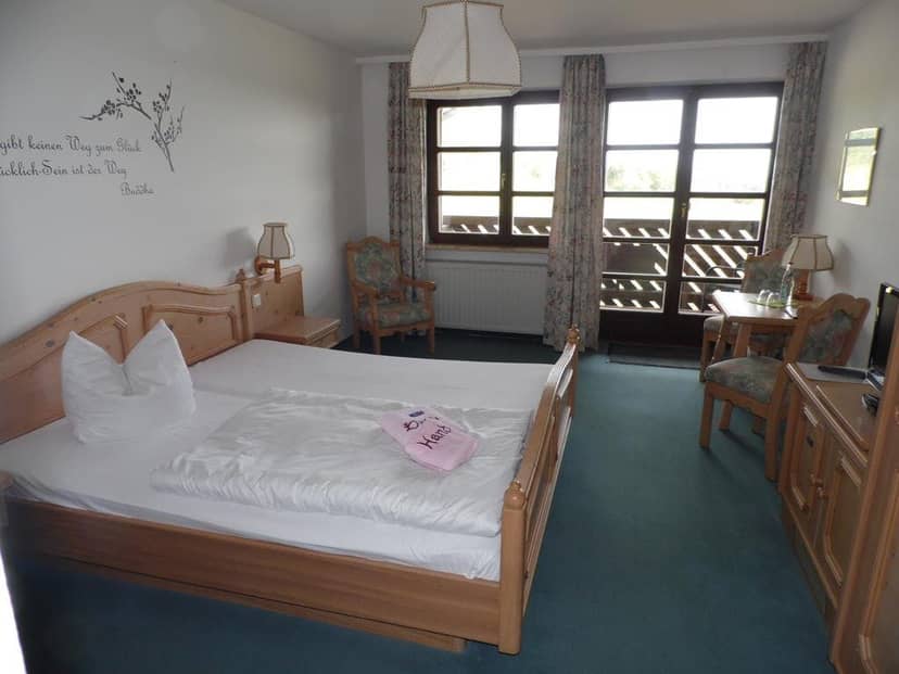 Budget-friendly guest room at Berggasthof & Hotel Kranich for affordable group travel lodging.