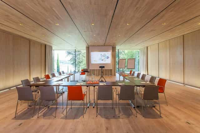 U-shape boardroom at La Villa with wood-paneled walls, ideal for executive meetings and workshops.