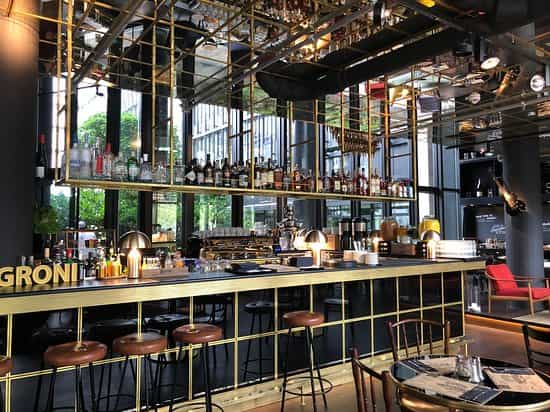 Industrial rooftop terrace bar with gold accents for upscale networking and corporate events.