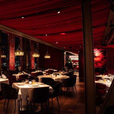 Wine Room at Ventuno Sky Lounge with red drapes for corporate dinners and VIP events.