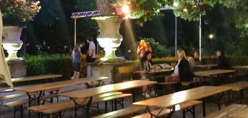 Münchner Stuben beer garden bench seating for relaxed outdoor evening networking events.
