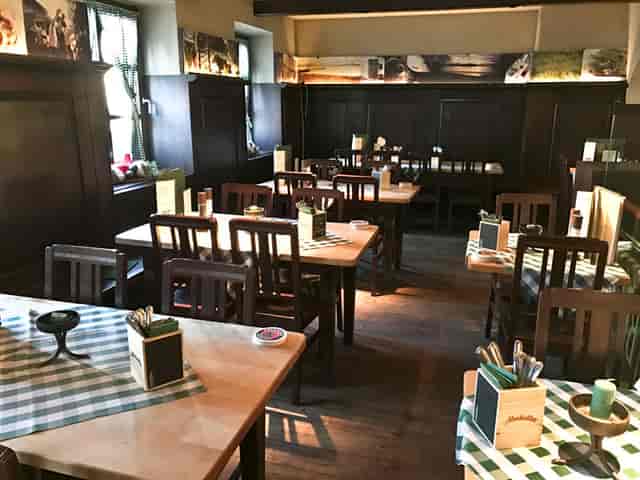 Wirtshaus zur Brezn rustic wood-paneled dining venue for team lunches and casual breakout sessions.