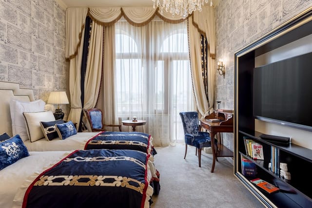 Luxury twin hotel room at Suter Palace for VIP speakers and incentive travel.