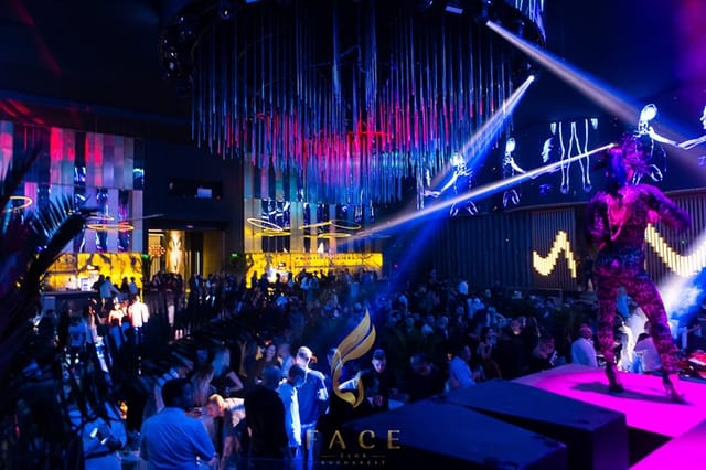 Corporate event at Face Club Bucharest with stage performer and dramatic lighting.