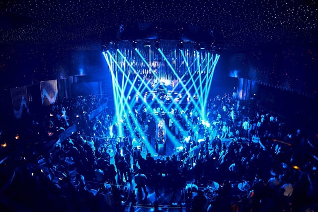 Face Club Bucharest gala event with dramatic circular lighting and star-field ceiling.